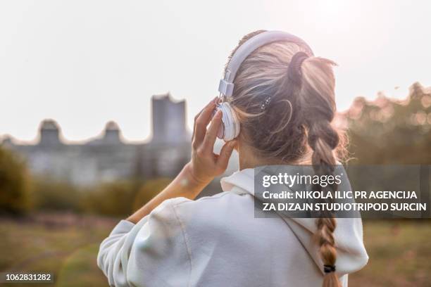 musik und training im park - pferdeschwanz stock-fotos und bilder