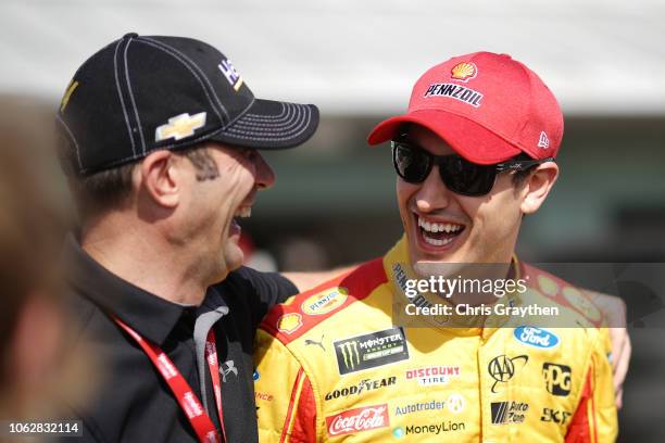 Joey Logano, driver of the Shell Pennzoil Ford, speaks with Max Papis during practice for the Monster Energy NASCAR Cup Series Ford EcoBoost 400 at...