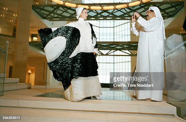 His Highness the Emir Sheikh Hamad bin Khalifa Al Thani photographs his wife Sheikha Mozah bint Nasser al-Missned inside the new Museum of Islamic...