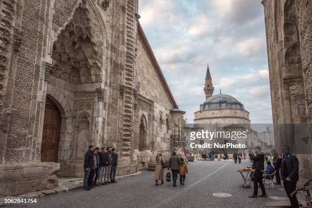 On 10 November 2018, tourists take photos between the historic Cifte Minare Medrese and the Sifaiye Medresesi in central Sivas, a city in Turkey's...