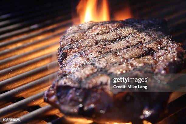 grilled steak with flame - grilled stock pictures, royalty-free photos & images