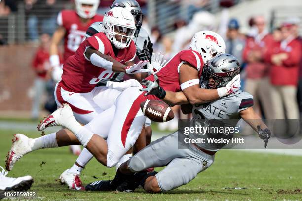 Johnathan Abram of the Mississippi State Bulldogs fumbles the ball after recovering a fumble in the first half of a game against the Arkansas...