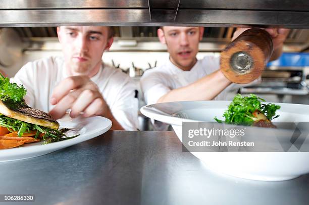 chefs doing kitchen preparation and service  - newbusiness stock pictures, royalty-free photos & images