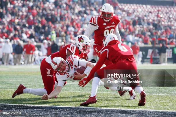 Ryan Finley of the North Carolina State Wolfpack gets stopped short of the goal line in the second quarter of the game against the Louisville...