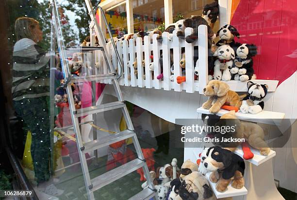 Worker puts the finishing touches to a window display in Selfridges as they launch their 2010 Christmas window display on October 28, 2010 in London,...