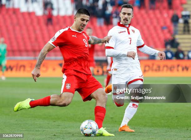 Aleksandar Mitrovic of Serbia in action against Marko Vesovic of Montenegro during the UEFA Nations League C group four match between Serbia and...