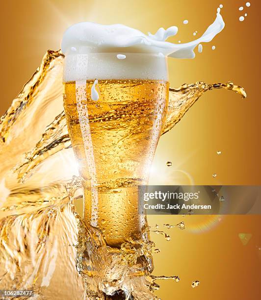 glass of beer with splash - beer splashing stock pictures, royalty-free photos & images