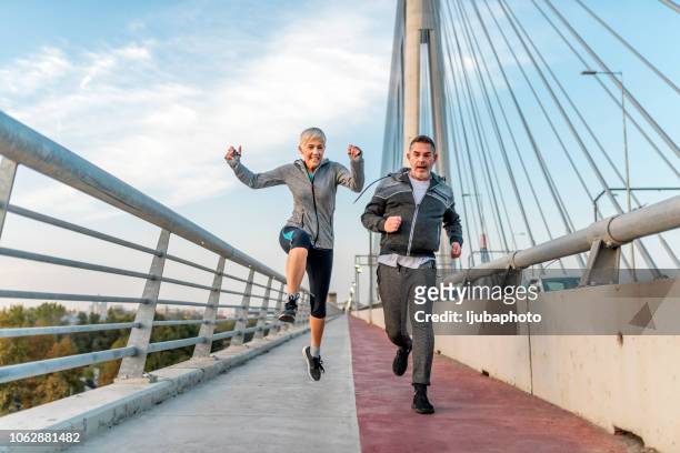 überwindung von hindernissen. - old couple jumping stock-fotos und bilder
