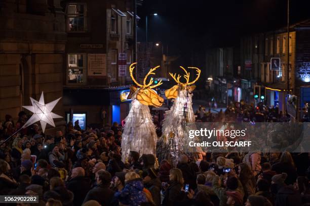 Performers and musicians parade through the streets of Todmorden, bearing giant lantern puppets and hundreds of paper lanterns for the Lamplighter...