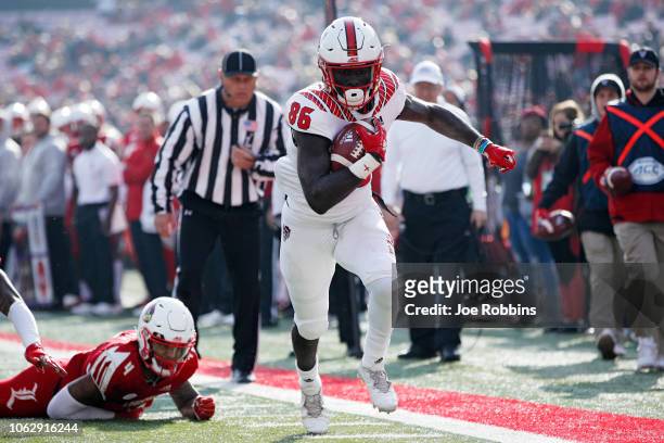 Emeka Emezie of the North Carolina State Wolfpack runs for the end zone with a 12-yard touchdown reception against the Louisville Cardinals in the...