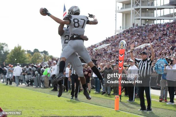 Dontavian Lee celebrates with Osirus Mitchell of the Mississippi State Bulldogs after scoring a touchdown in the second half of a game against the...