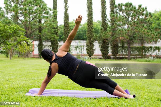 young woman practicing yoga on her backyard. - showus yoga stock pictures, royalty-free photos & images