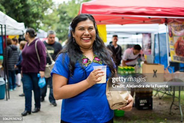 cheerful woman shopping at the street market. - mexican street market stock pictures, royalty-free photos & images