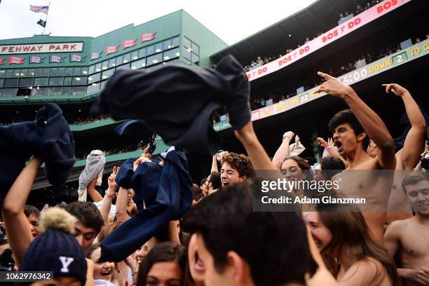 Yale Bulldogs fans take off their clothes and cheer as part of a tradition during a game against the Harvard Crimson at Fenway Park on November 17,...