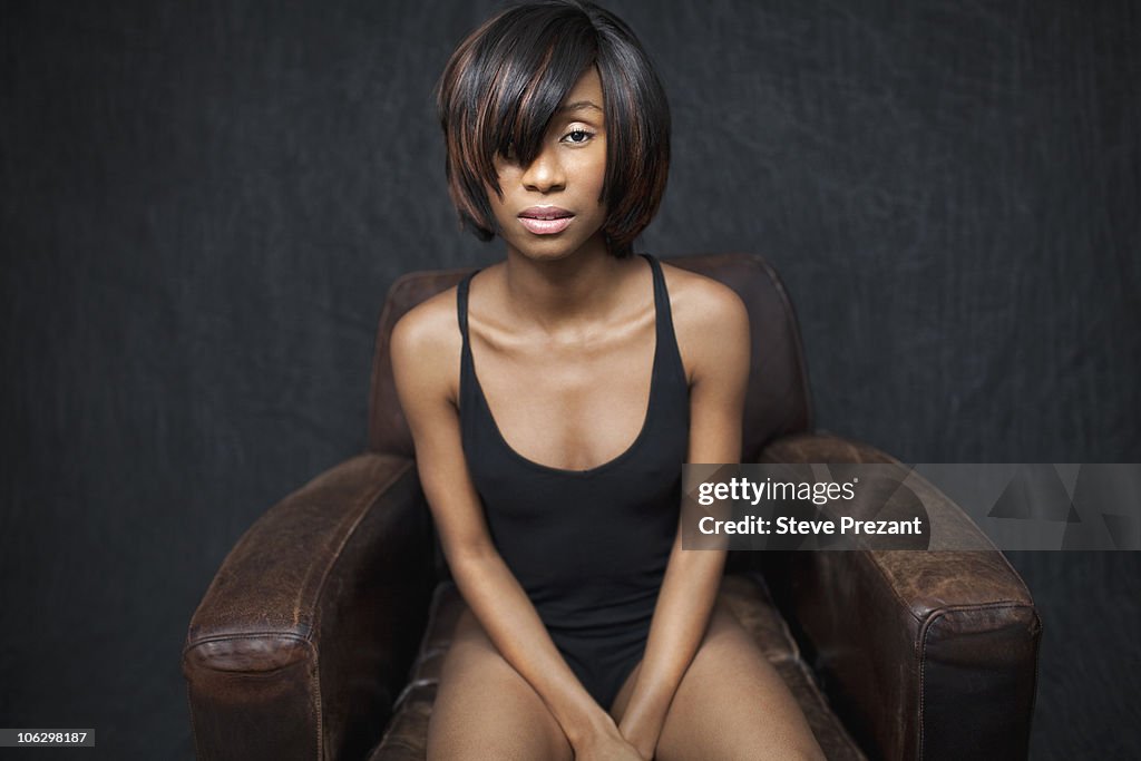 Black woman sitting in leather armchair
