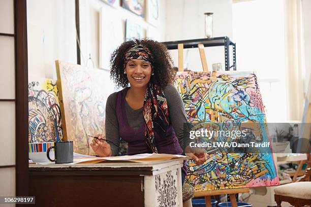 mixed race artist working in studio - black artist stock pictures, royalty-free photos & images