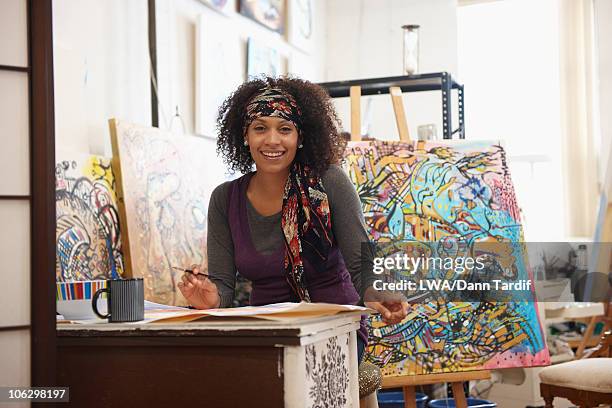 mixed race artist working in studio - black culture art stock pictures, royalty-free photos & images
