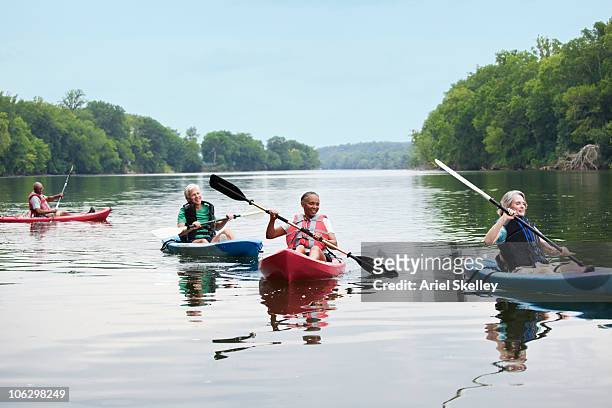 Couples kayaking on river