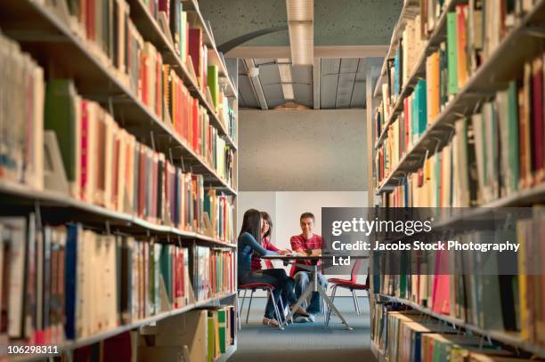 students studying at library table - university library stock pictures, royalty-free photos & images