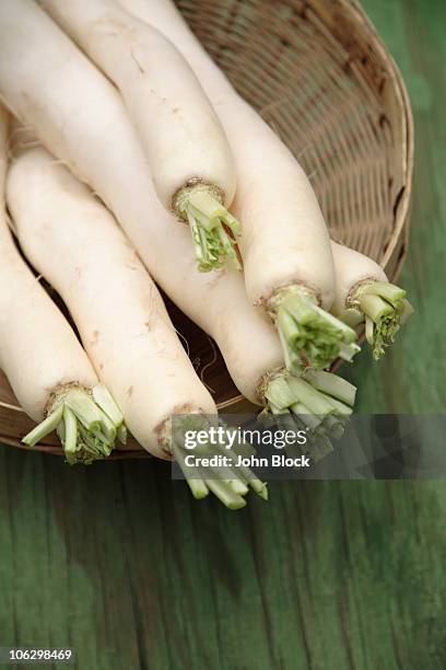 daikon radishes in basket - daikon stock pictures, royalty-free photos & images