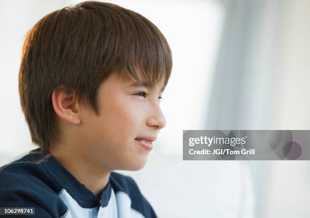 pensive mixed race boy - 少年　横顔 ストックフォトと画像