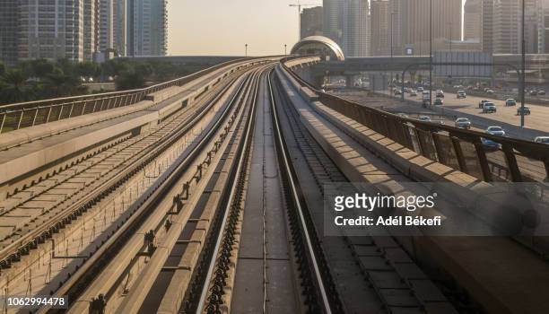 dubai metro sunlight (dubai, uae) - railway tracks sunset stock pictures, royalty-free photos & images