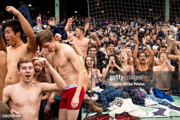 Fans remove items of clothing during a game between the Yale Bulldogs and the Harvard Crimson during a game on November 17, 2018 at Fenway Park in...