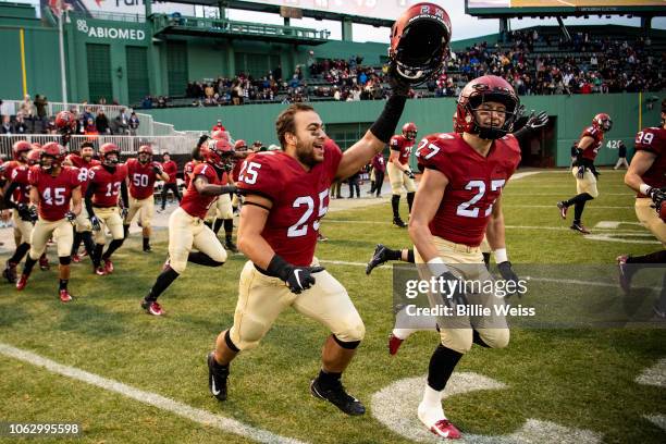 Members of the Harvard Crimson react after defeating the Yale Bulldogs during a game on November 17, 2018 at Fenway Park in Boston, Massachusetts.