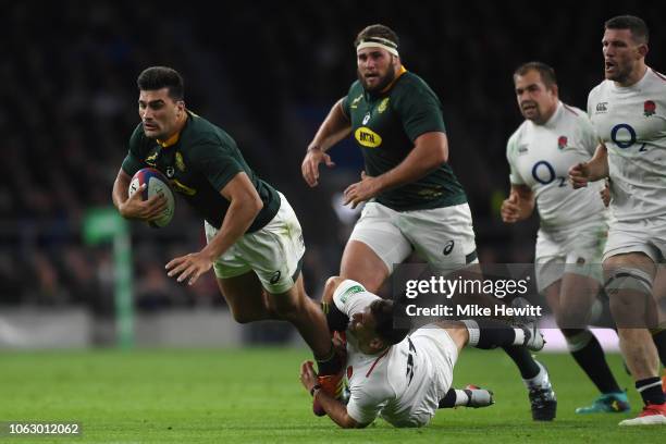 Damian de Allende of South Africa is tackled by Danny Care of England during the Quilter International match between England and South Africa at...