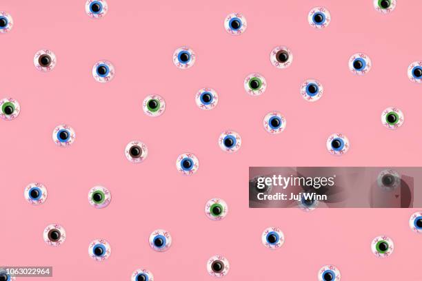 bloodshot eyeballs on a pink background. - dry eye stock pictures, royalty-free photos & images