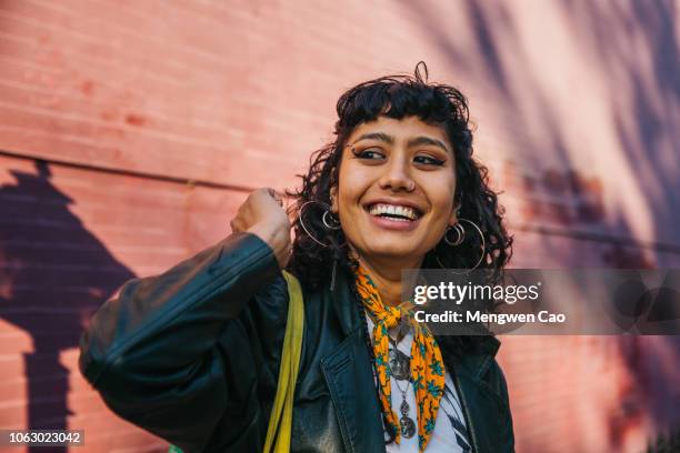 young confident woman smiling - new york person strasse stock-fotos und bilder