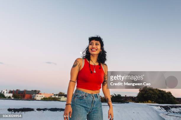 portrait of young woman on rooftop - tatouage femme photos et images de collection