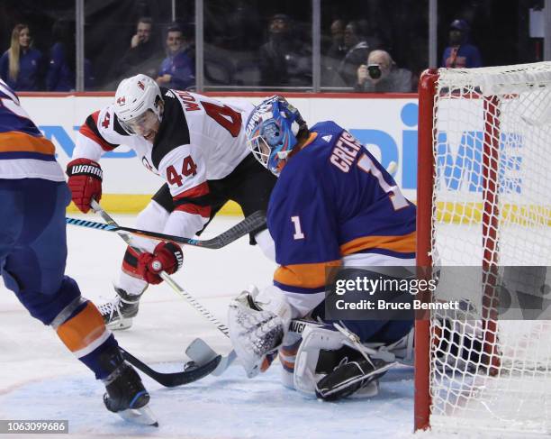 Thomas Greiss of the New York Islanders makes the first period save on Miles Wood of the New Jersey Devils at the Barclays Center on November 03,...