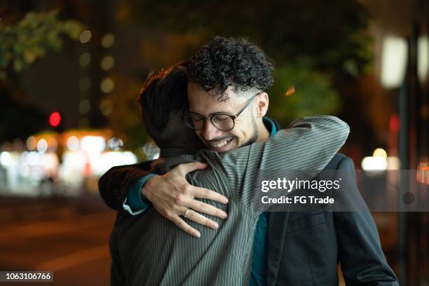expression of greeting - men hugging stock pictures, royalty-free photos & images
