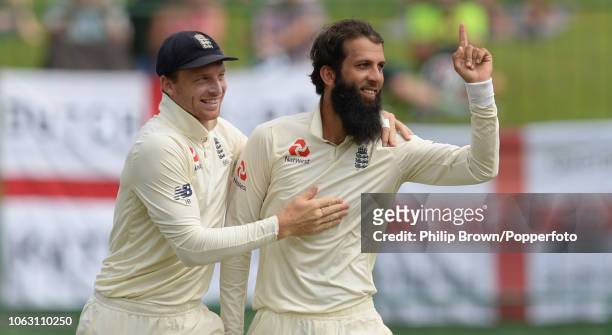Moeen Ali celebrates with Jos Buttler of England after the dismissal of Niroshan Dickwella during the 2nd Cricket Test Match between Sri Lanka and...