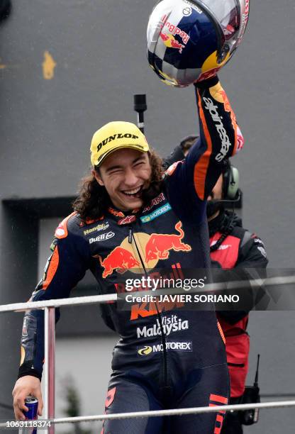 Race winner Red Bull KTM Ajo's Turkish rider Can Oncu celebrates on the podium after the Moto3 race of the Valencia Grand Prix at the Ricardo Tormo...