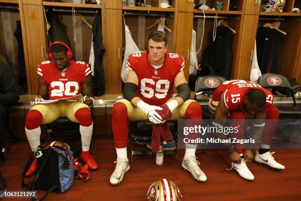 Jimmie Ward, Mike McGlinchey and Pierre Garcon of the San Francisco 49ers relax in the locker room prior to the game against the Oakland Raiders at...