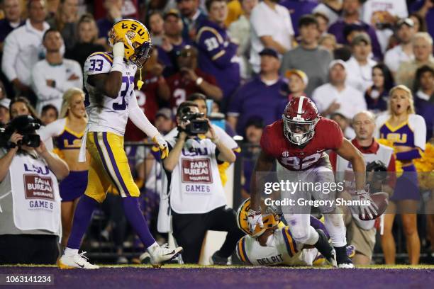 Irv Smith Jr. #82 of the Alabama Crimson Tide celebrates a touchdown as Todd Harris Jr. #33 of the LSU Tigers looks on in the second quarter of their...