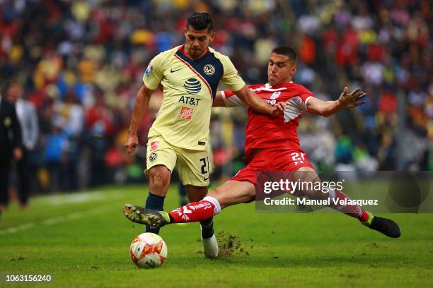 Henry Martin of America struggles for the ball against Enrique Triverio of Toluca during a 15th round match between Club America and Toluca as part...