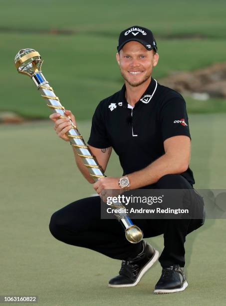 Danny Willett of England poses with the DP World Tour trophy following victory in the final round of the DP World Tour Championship at Jumeirah Golf...