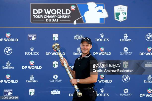 Danny Willett of England poses with the DP World Tour trophy following victory in the final round of the DP World Tour Championship at Jumeirah Golf...