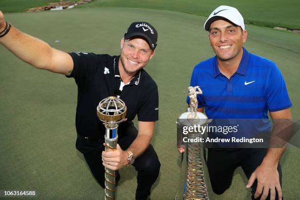 Danny Willett of England poses with the DP World Tour trophy alongside Francesco Molinari of Italy posing with the Race to Dubai trophy following the...