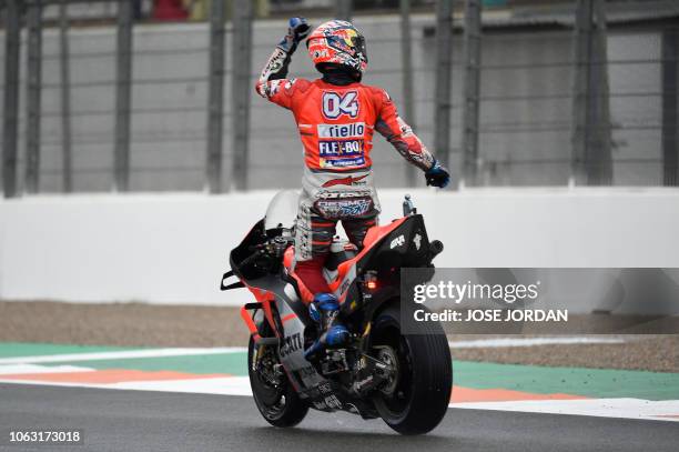 Ducati Team's Italian rider Andrea Dovizioso celebrates winning the MotoGP race of the Valencia Grand Prix at the Ricardo Tormo racetrack in Cheste,...