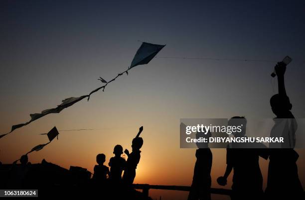 Young Rohingya refugees fly kites at the Hakimpara refugee camp in Bangladesh's Cox's Bazar district on November 18, 2018. - Rohingya Muslims were...