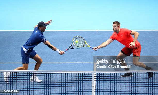 Jack Sock and Mike Bryan of The United States return the ball during thier doubles final against Pierre-Hugues Herbert and Nicolas Mahut of France...