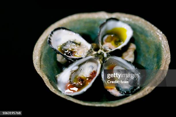 luxury cuisine, oysters with sauce in blackground - cancale bildbanksfoton och bilder
