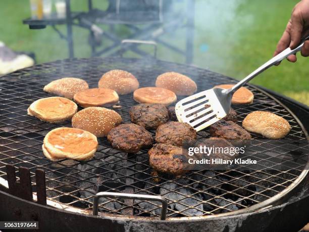 cooking burgers and buns on a grill - tailgate stock pictures, royalty-free photos & images