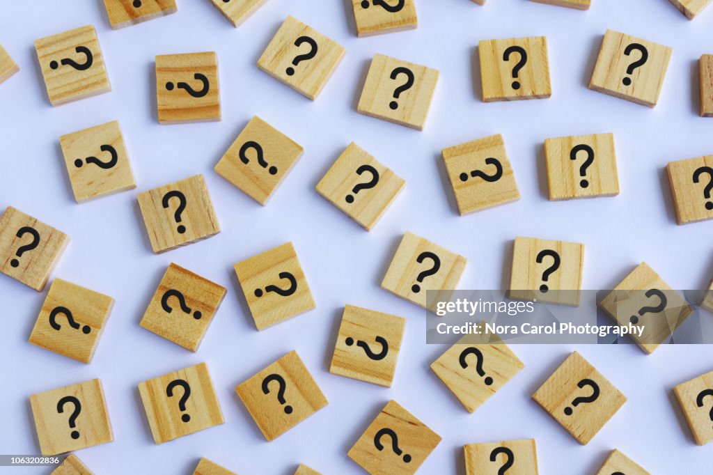 Question Marks on Wooden Block White Background