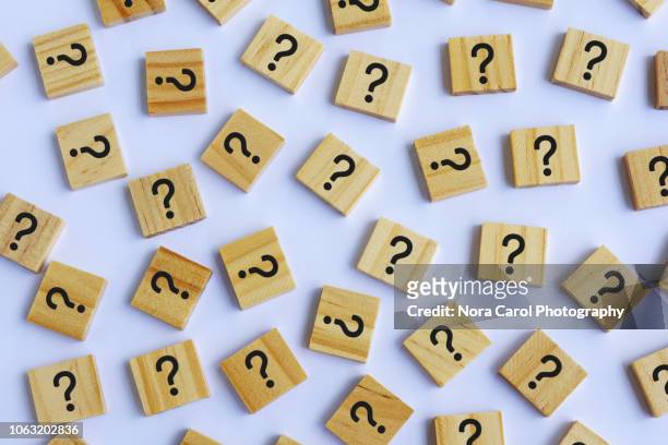 question marks on wooden block white background - answering stock pictures, royalty-free photos & images