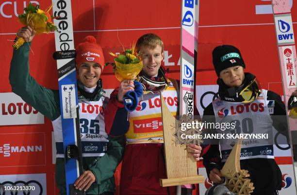 Germany's Stephan Leyhe, Russia's Evgeniy Klimov and Japan's Ryoyu Kobayashi celebrates on the podium after the the FIS Ski Jumping World Cup in...